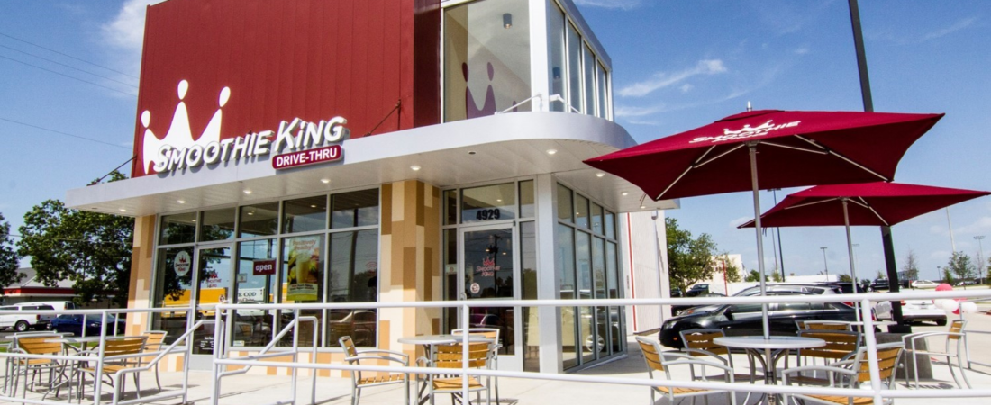 Smoothie King Storefront Smoothie King storefront with red signage and outdoor patio seating.