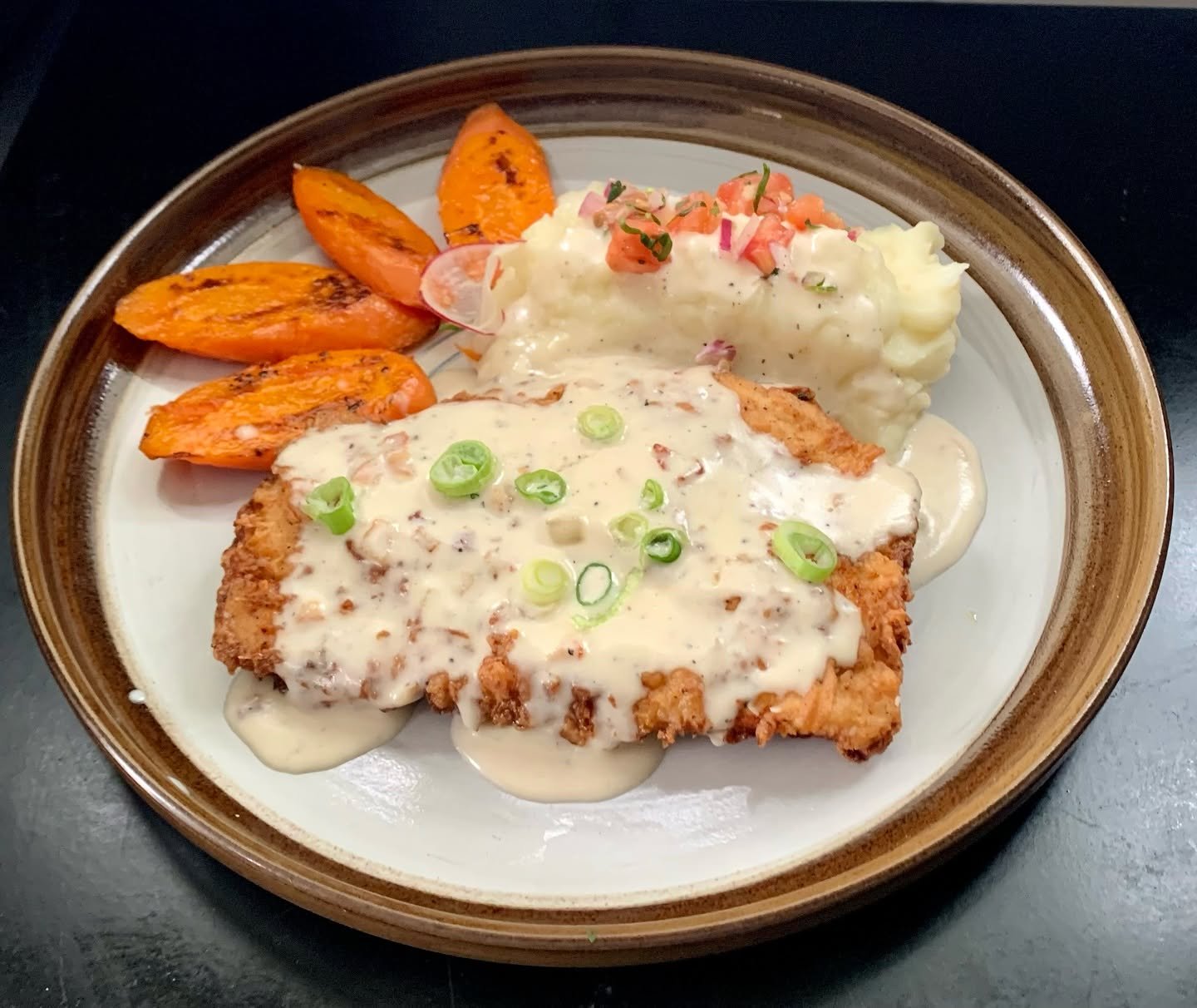 ATOS International Cuisine breaded entrée with cream gravy, mashed potatoes and carrots