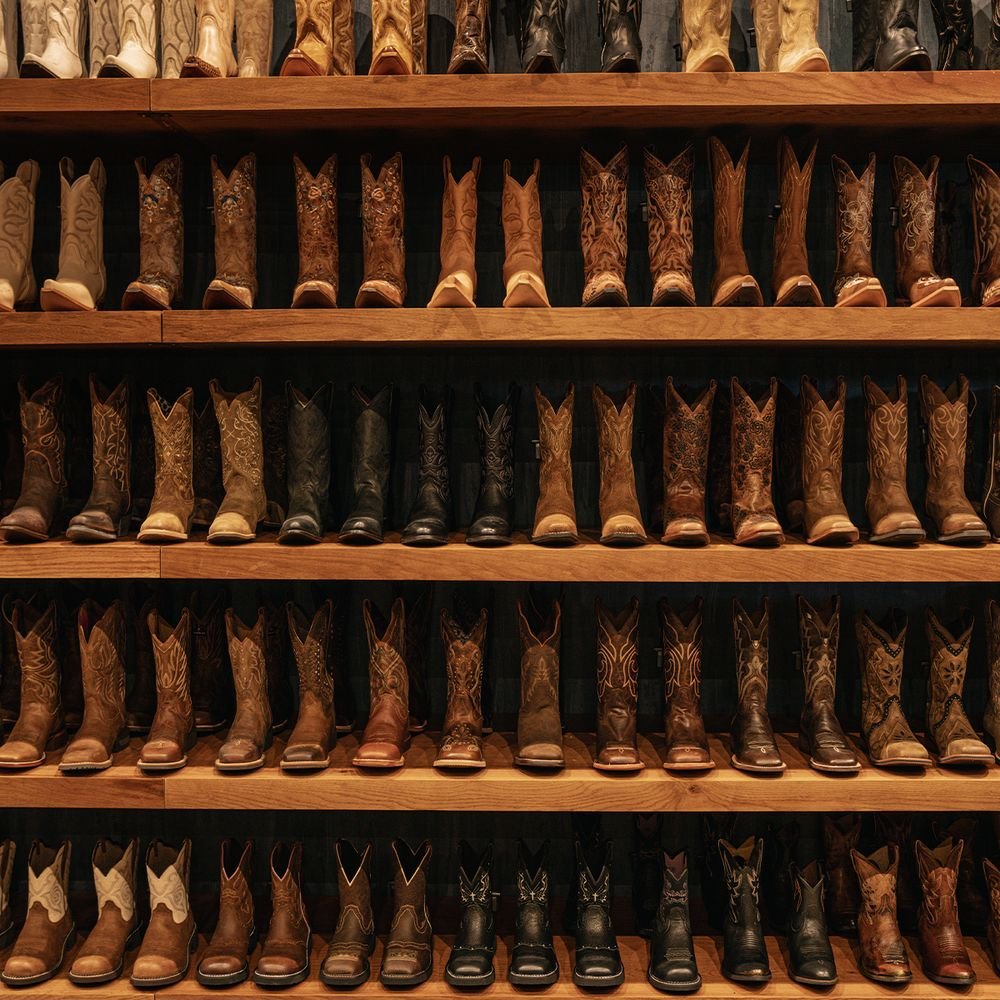 Western Boots Display Rows of Western boots displayed on wooden shelves in Boot Barn