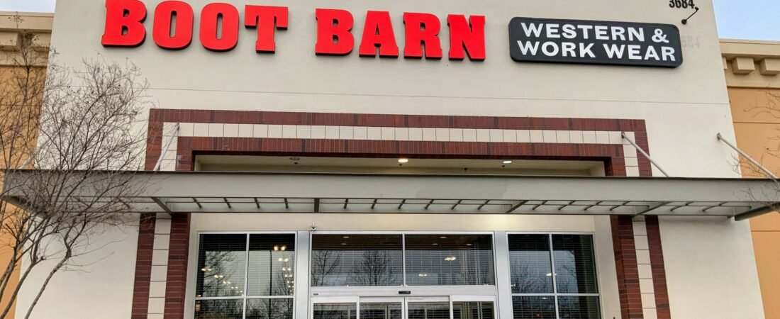 Boot Barn Store Exterior Boot Barn storefront with red lettering and Western and Work Wear sign