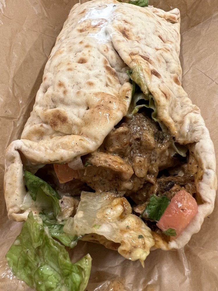 CAVA chicken pita filled with lettuce, tomatoes and sauce