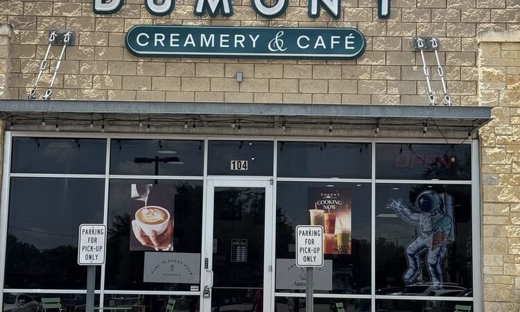 Dumont Creamery and Cafe storefront with green signage and outdoor seating