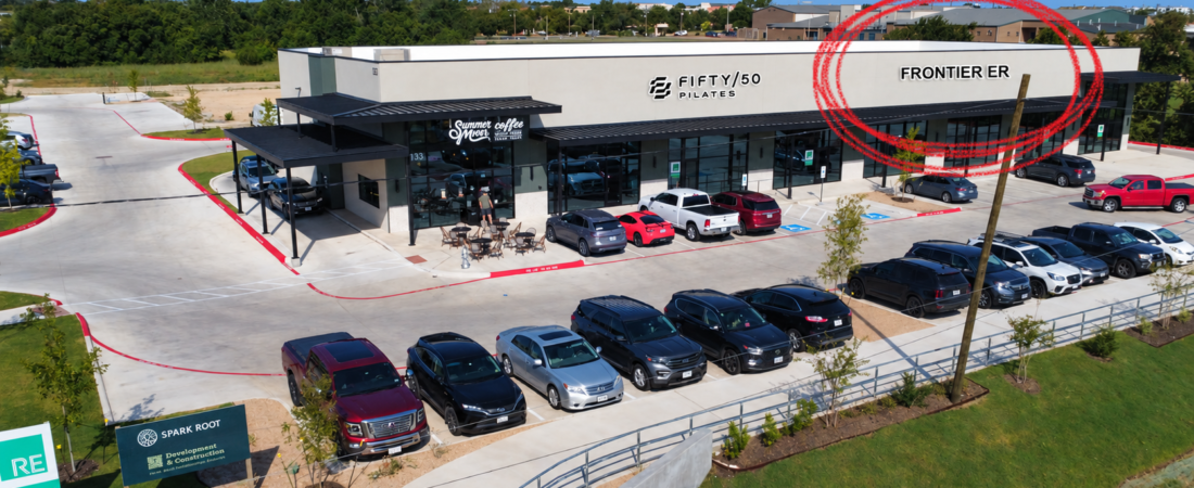 Marketing image identifying the planned Frontier ER space beside Fifty/50 Pilates and Summer Moon in Leander.
