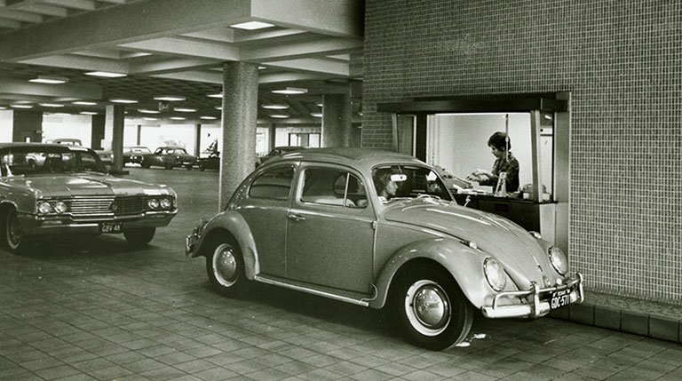Frost motor bank opening in 1965 with a Volkswagen Beetle at the teller window