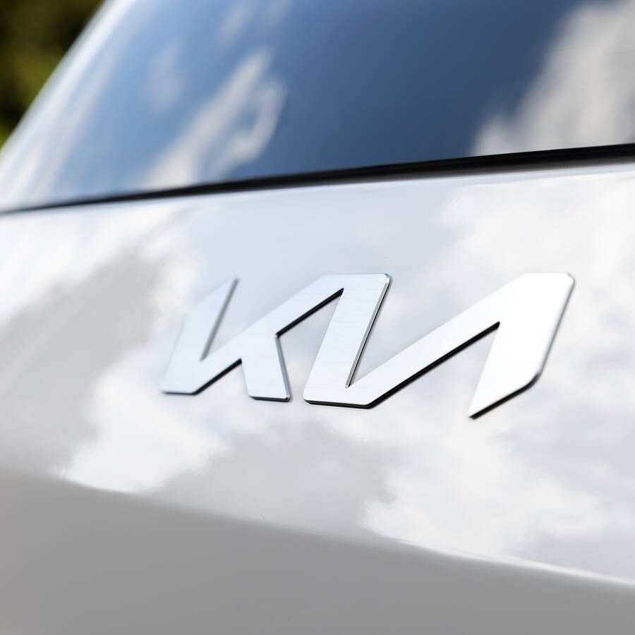 Kia emblem on the hood of a white EV9