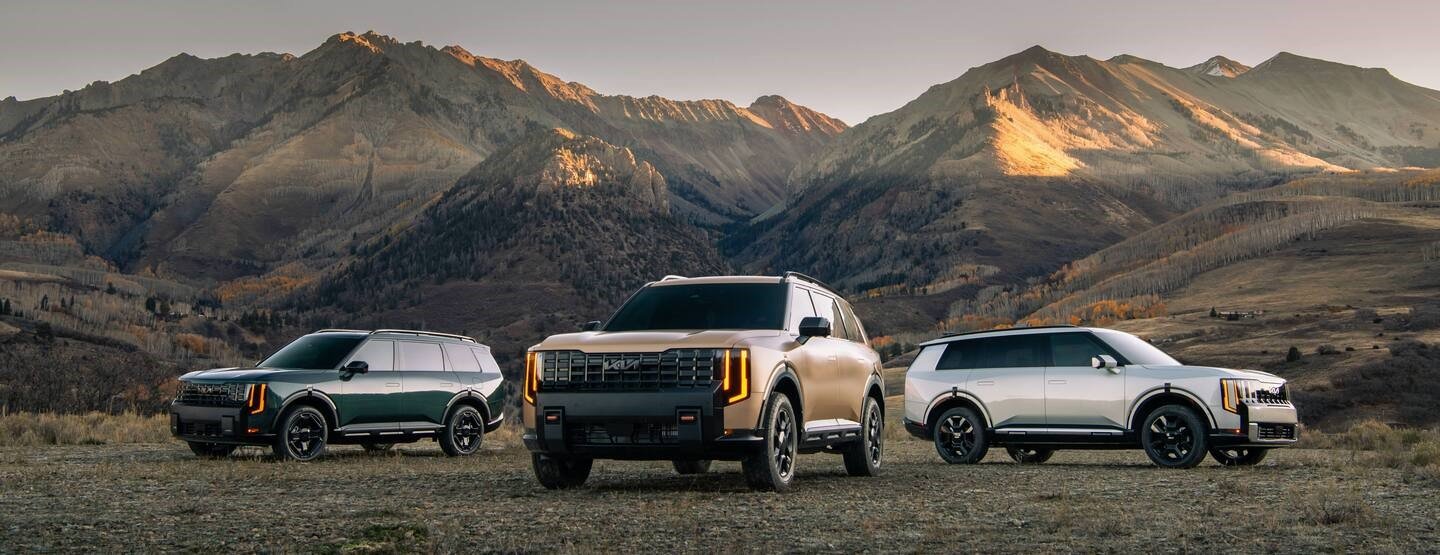 Three 2027 Kia Telluride SUVs photographed against a mountain landscape