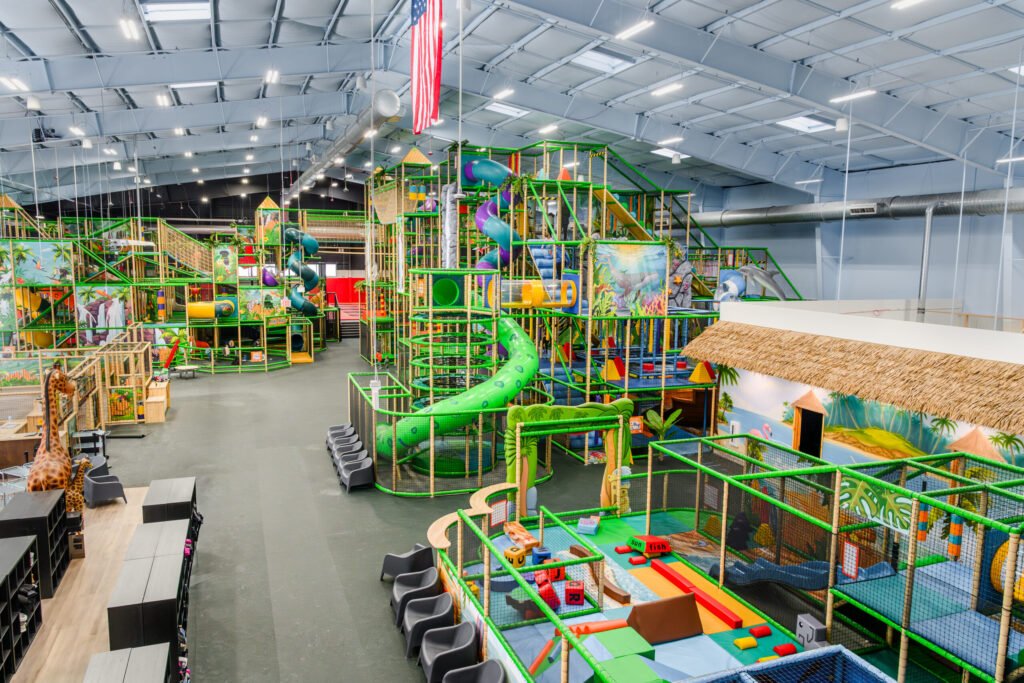 Lava Island indoor playground with colorful slides, climbing structures, and tropical decor.