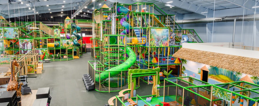 Lava Island Indoor Playground Lava Island indoor playground with colorful slides, climbing structures, and tropical decor.