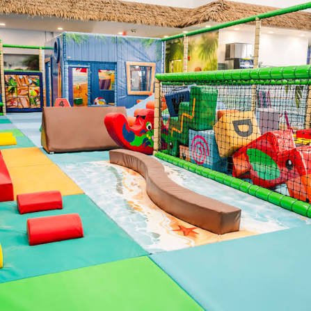 Lava Island Toddler Play Area Lava Island toddler play area with padded flooring, soft obstacles, and colorful play equipment.