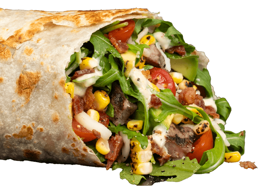 Piada flatbread wrap filled with meat, greens, tomatoes, corn, and sauce.