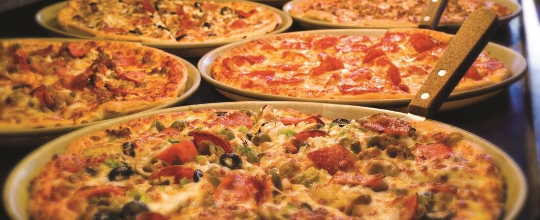 Pizza Ranch Pizza Buffet Assorted pizzas with cheese, meat, and vegetable toppings on a Pizza Ranch buffet.