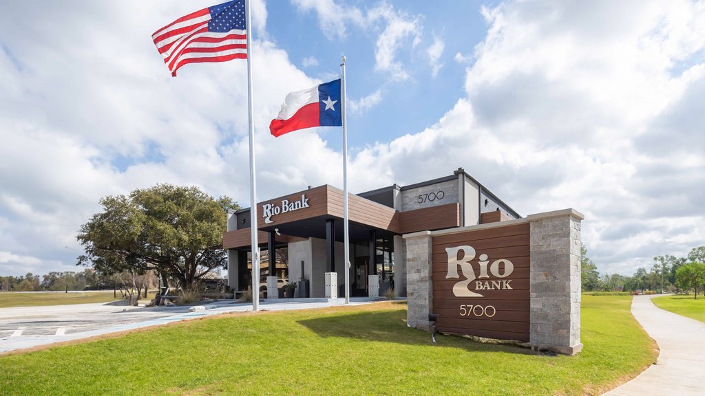 Representative Rio Bank exterior with drive-through canopy and flags; not the Rio Bank Jackson project