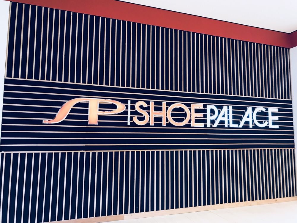 Illuminated Shoe Palace logo and lettering on a store wall