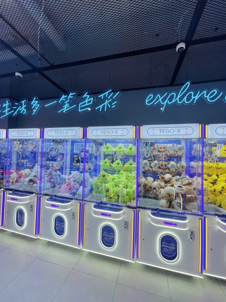 TESO-X claw machines TESO-X claw machines filled with colorful plush toys at an existing store