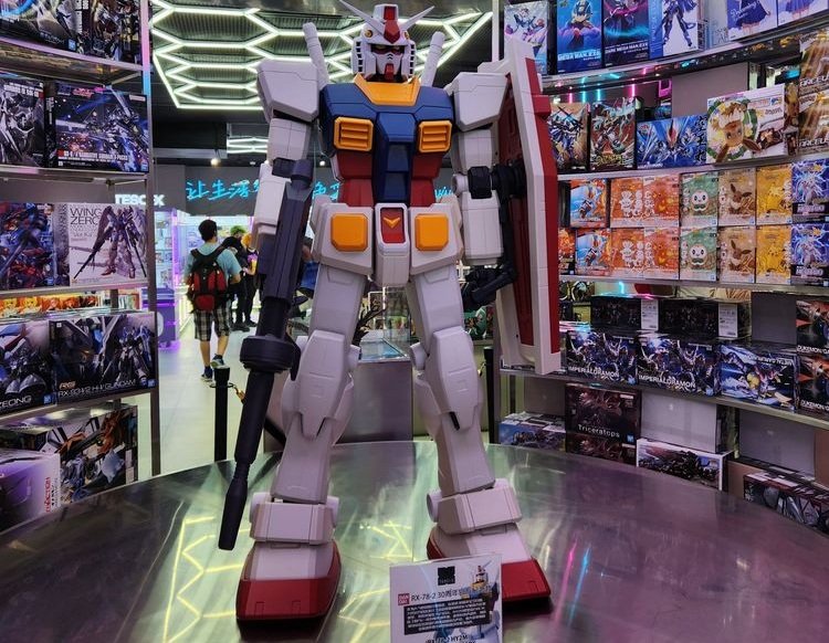 Large robot figure surrounded by shelves of collectible model kits at an existing TESO-X store