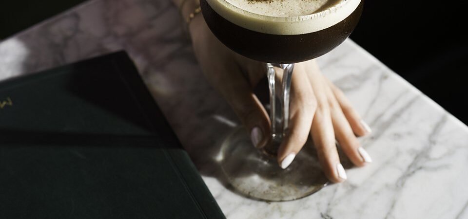 The Henry Cocktail Foam-topped cocktail with an H garnish at The Henry.