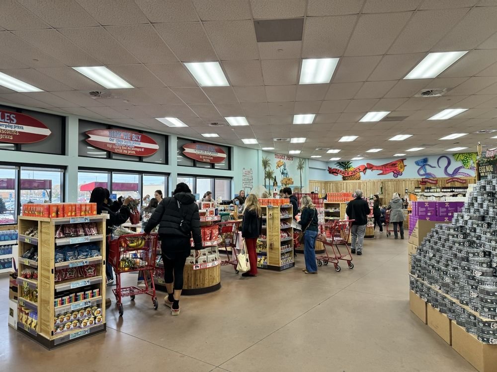Trader Joe’s checkout area Shoppers and red carts in a Trader Joe’s checkout area