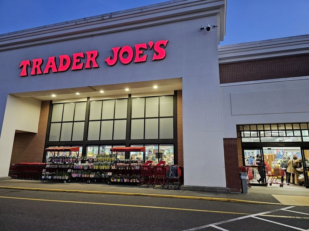 Trader Joe’s storefront with red lettering, shopping carts, and entrance