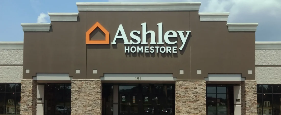 Ashley Homestore exterior with storefront sign and stone columns
