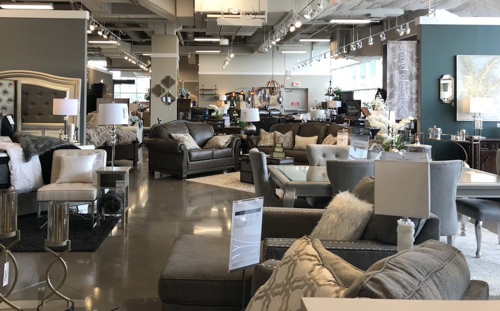 Ashley furniture showroom with sofas, dining tables and bedroom displays — representative imagery for Ashley Homestore Fort Worth plans