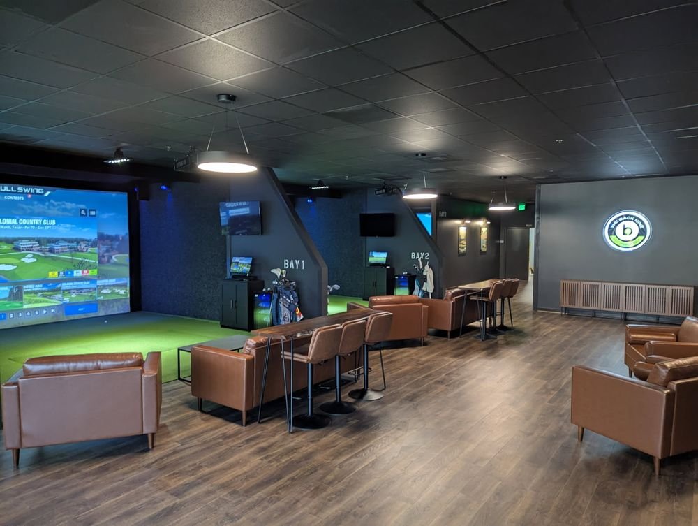 Back Nine Golf interior with simulator bays, leather chairs and seating areas