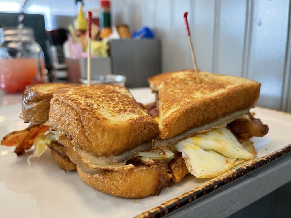 Toasted breakfast sandwich with egg and bacon, representative food for the Brunch District Celina story