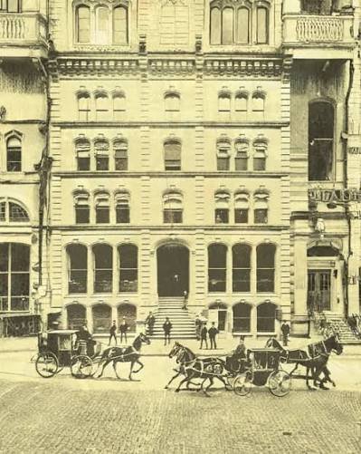 Historic Banking Streetscape Historic Chase Bank multistory building with horse-drawn carriages along the street