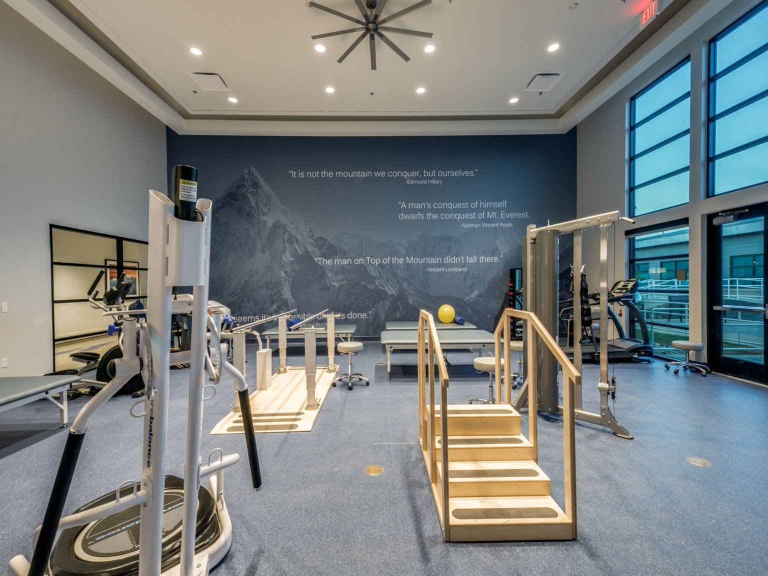 Everest Rehabilitation Hospital therapy gym with practice stairs, parallel bars and exercise equipment