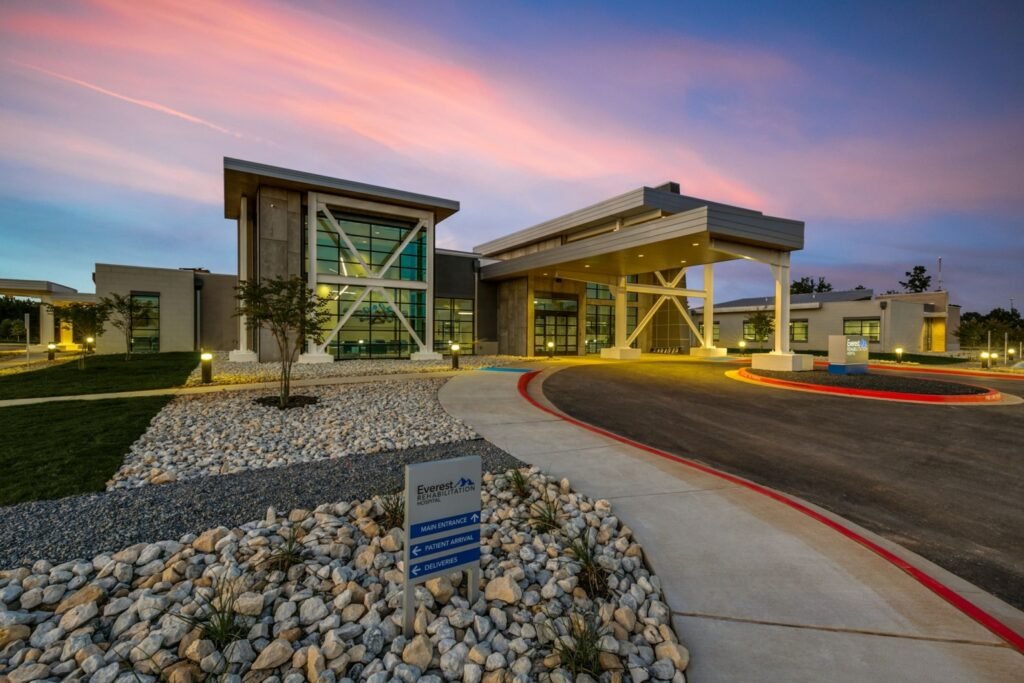 Existing Everest Rehabilitation Hospital exterior with a covered entrance at sunset