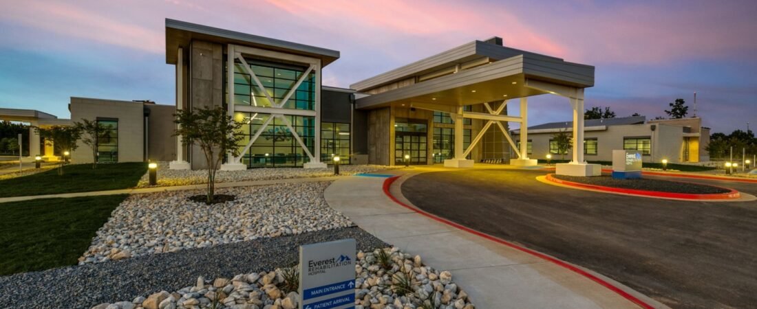 Existing Everest Rehabilitation Hospital exterior with a covered entrance at sunset