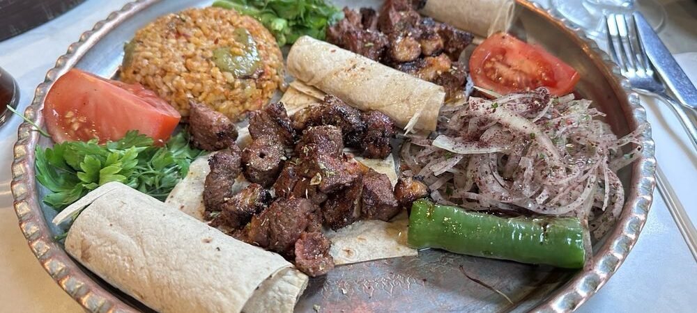 Huqqabaz food platter with meat, flatbread, tomatoes, onions and peppers