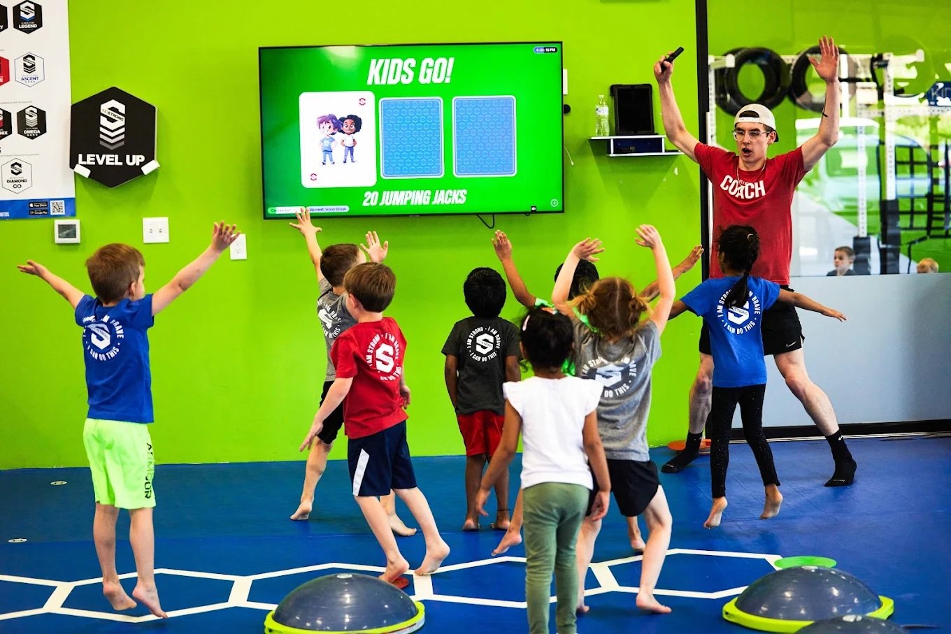 KidStrong Coach-Led Class KidStrong coach leading children through a class activity