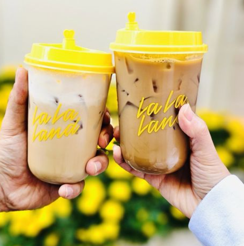 lalalanddrinks Two iced drinks in yellow-lidded branded cups, representative imagery for the La La Land Cafe Cypress story