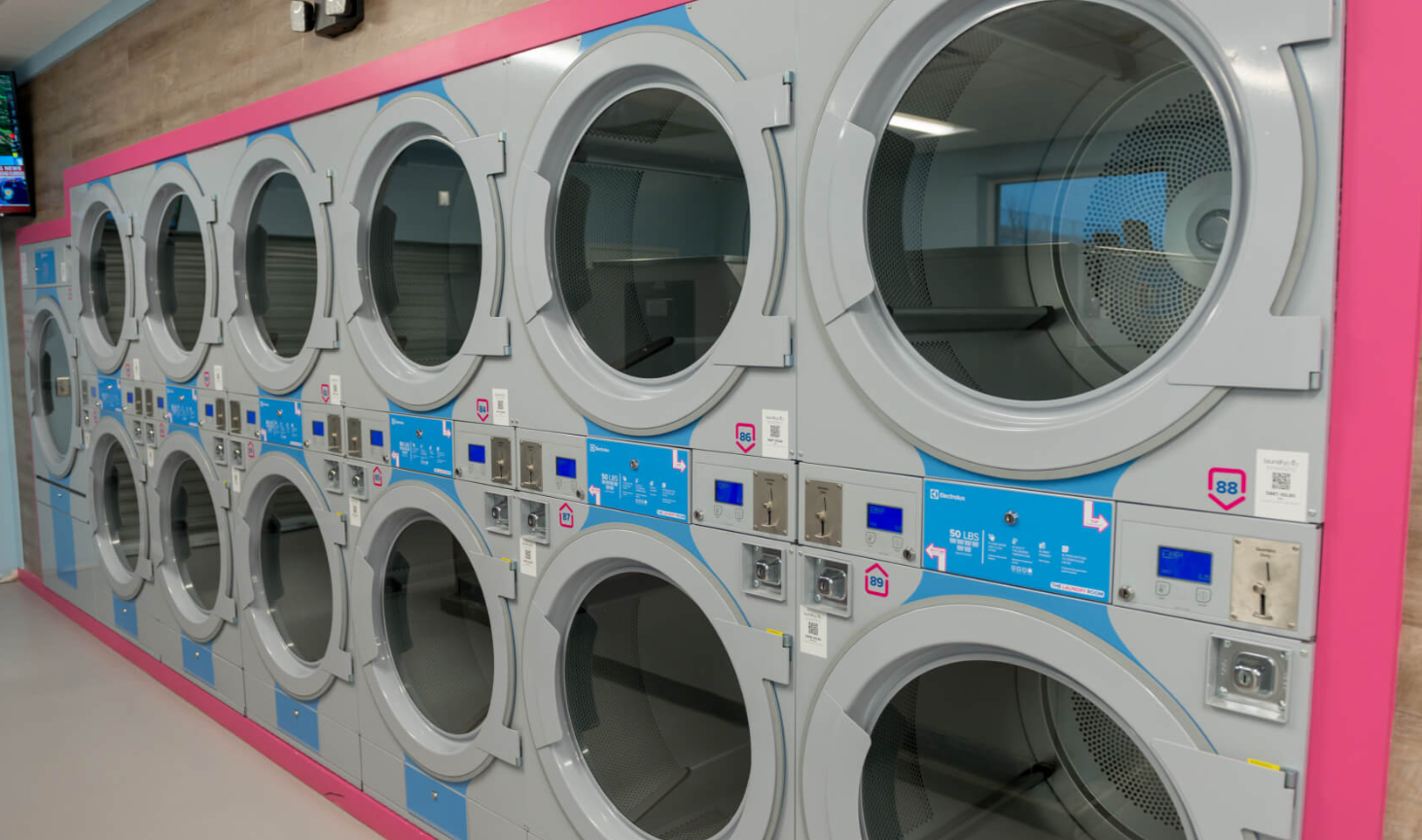 laundrolabinterior Stacked dryers at an existing LaundroLab, representative of the brand behind LaundroLab Round Rock