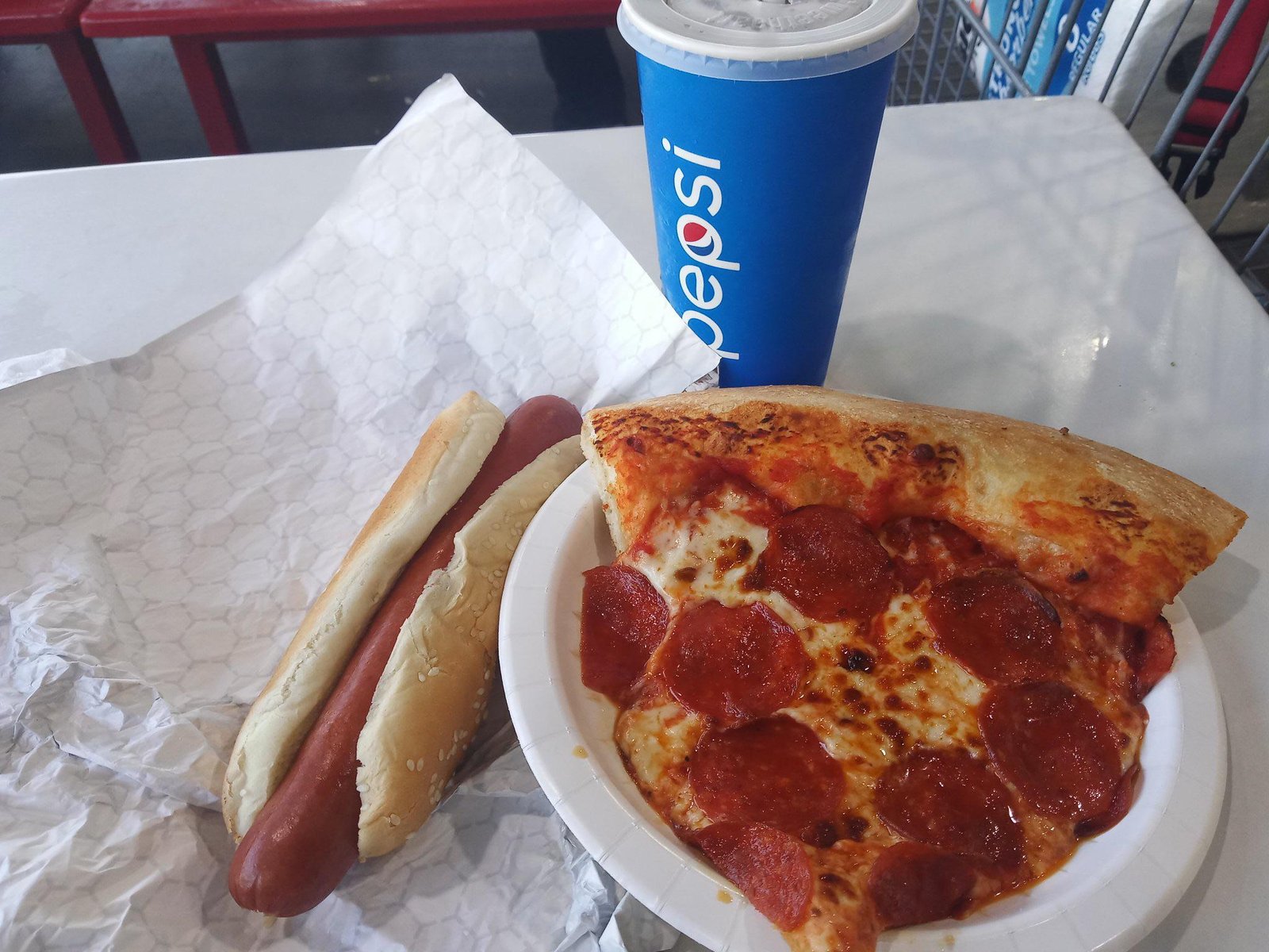 Costco Food Court Pizza and Hot Dog Costco food court pepperoni pizza slice, hot dog and fountain drink on a table