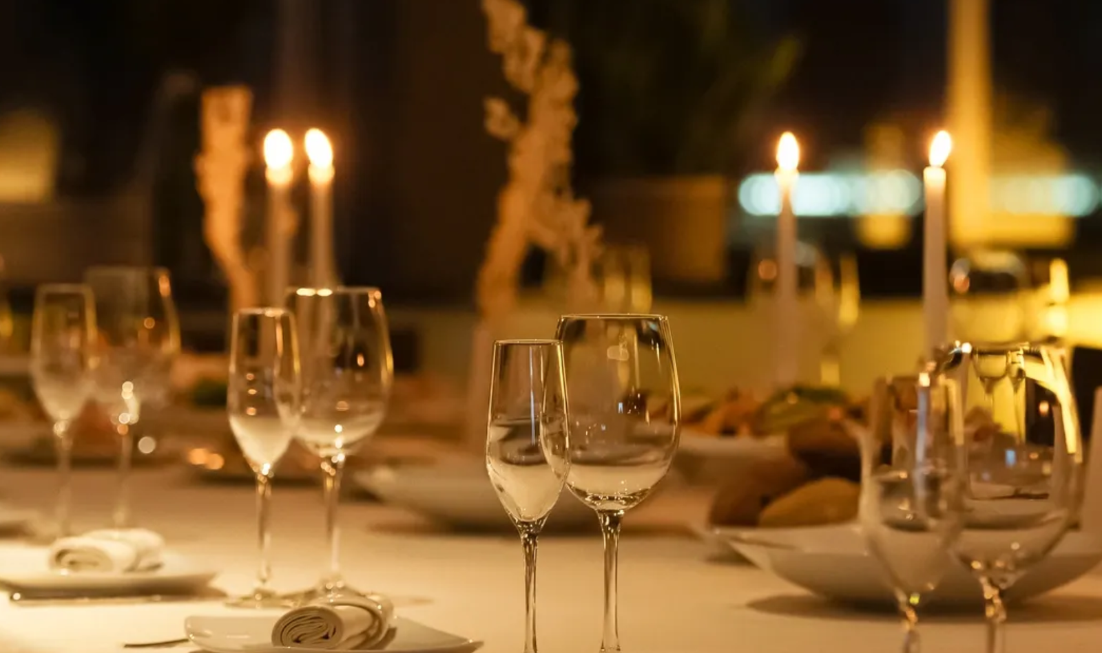 Candlelit dining table pictured on the website for the planned Proper Ash Steakhouse Dripping Springs concept