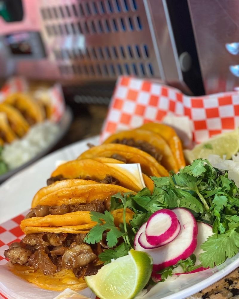 Taquería Ay Cocula El Paso tacos served with cilantro, radishes and lime