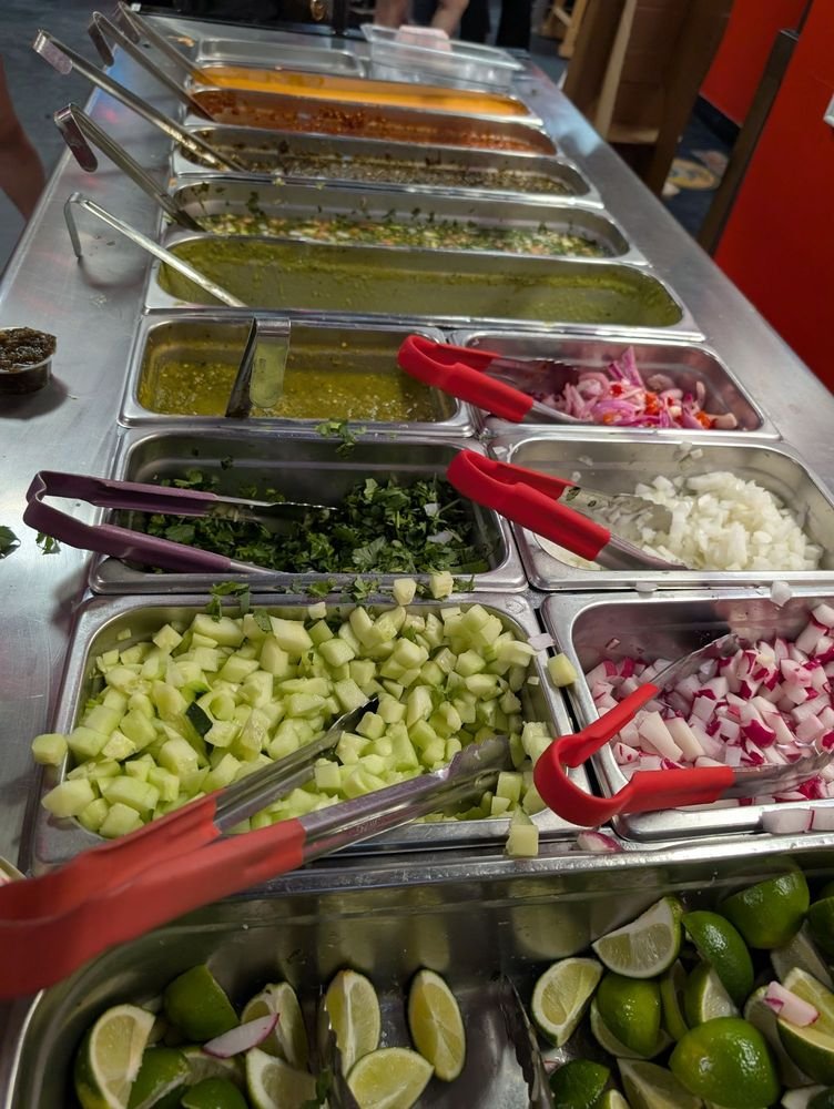 taqueriaaycoculatoppingsbar Taquería Ay Cocula El Paso toppings bar with limes, radishes, onions, cilantro and salsas