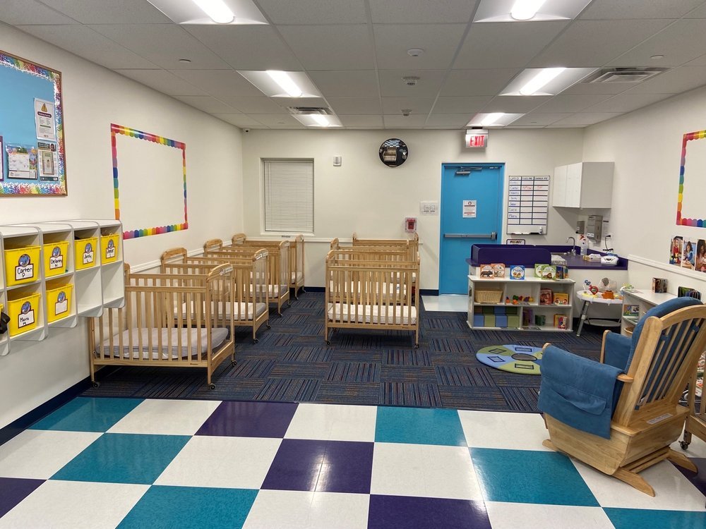 thelearningexperienceinfantroom The Learning Experience infant room with cribs, storage cubbies and a rocking chair