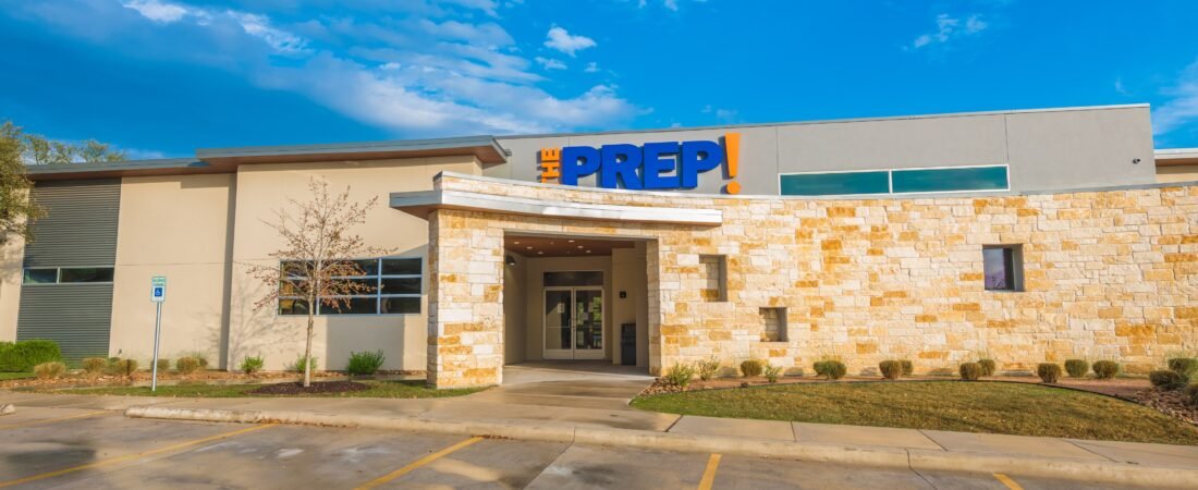 The PREP School Exterior Exterior of a PREP School with a stone facade and blue and orange signage