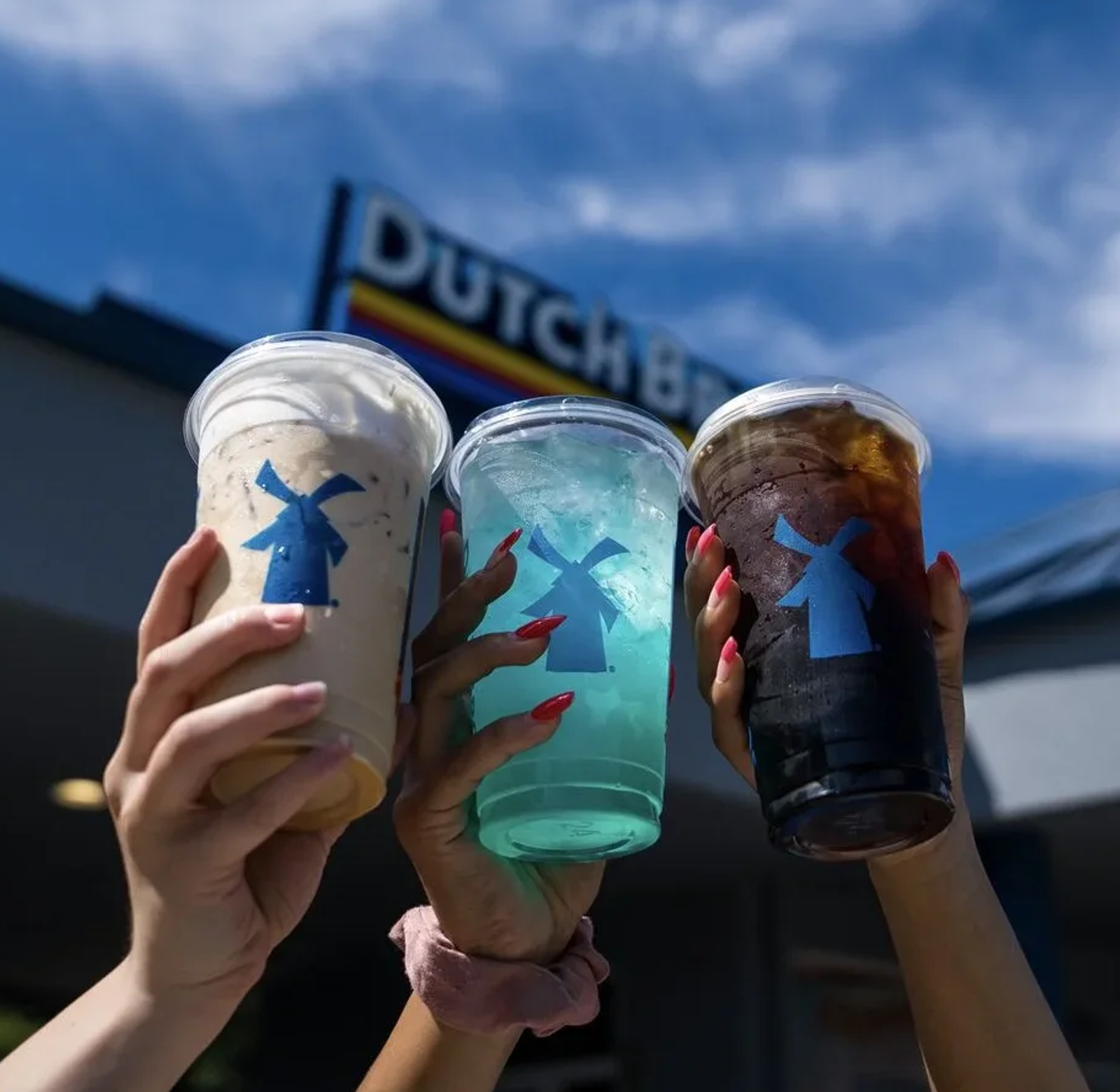 Three colorful Dutch Bros drinks in branded cups