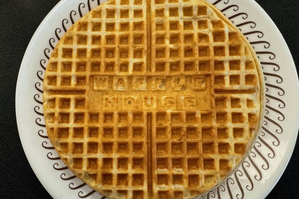 Waffle House Golden Waffle Golden Waffle House waffle on a patterned white plate.