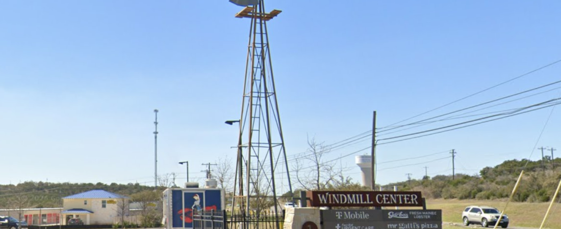 Windmill and entrance sign at the planned Proper Ash Steakhouse Dripping Springs location in Windmill Center