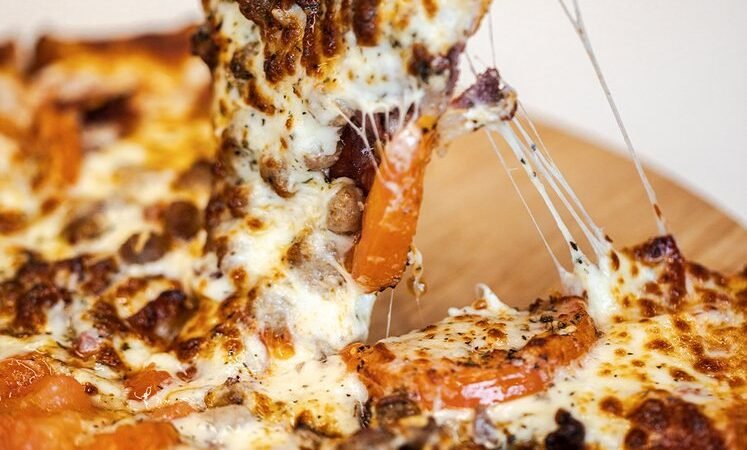 Representative Zio Al's Sunnyvale story image showing a slice lifted from a freshly baked pizza